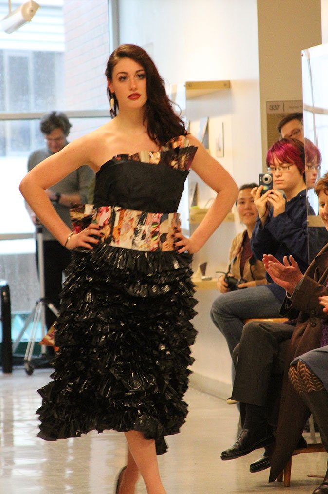 Elizabeth Kunkle, a junior in the industrial design program, models a trash fashion dress of plastic bags and magazine pages in a preview for the upcoming Trash Fashion Show in April. Photo by Becky Tachihara | University Communications intern