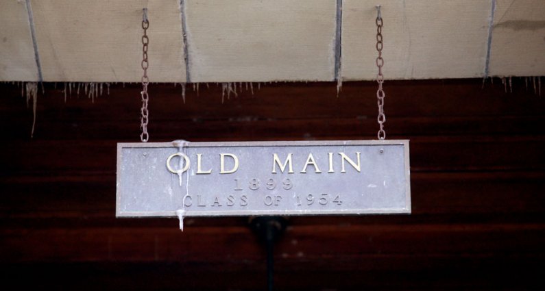 <p>
	A sign hanging above the third-floor entrance to Old Main is decked with icicles formed from water gushing from a broken pipe on the fifth floor of the building. Photo by Matthew Anderson | WWU</p>
