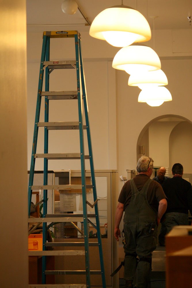 <p>
	Facilities workers survey the damage in the offices of the president and provost on the fourth floor of Old Main. Photo by Brooke Loisel | University Communications intern</p>
