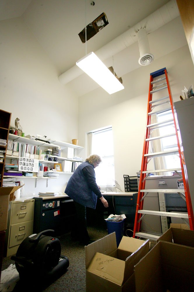 <p>
	Elva Giddings, interim director of Prevention and Wellness Services on the fifth floor of Old Main, cleans her office, which was the epicenter of the disaster. Tuesday night, a pipe burst in the ceiling above her office and flooded much of the build