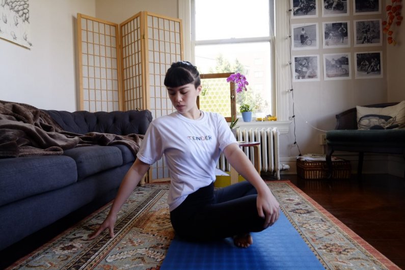 Megan Raventos, an aspiring Human Services major from Manhattan Beach, California takes a yoga break from online classes.
