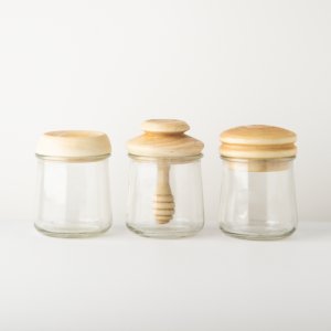 Three small jars with maple lids, made by student Megan Ostrowski
