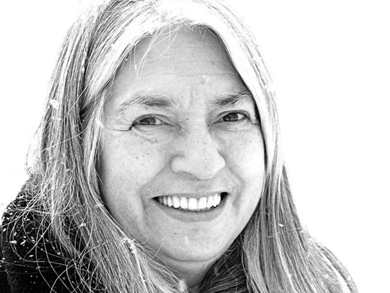 Lee Maracle smiles at the camera as snow falls around her