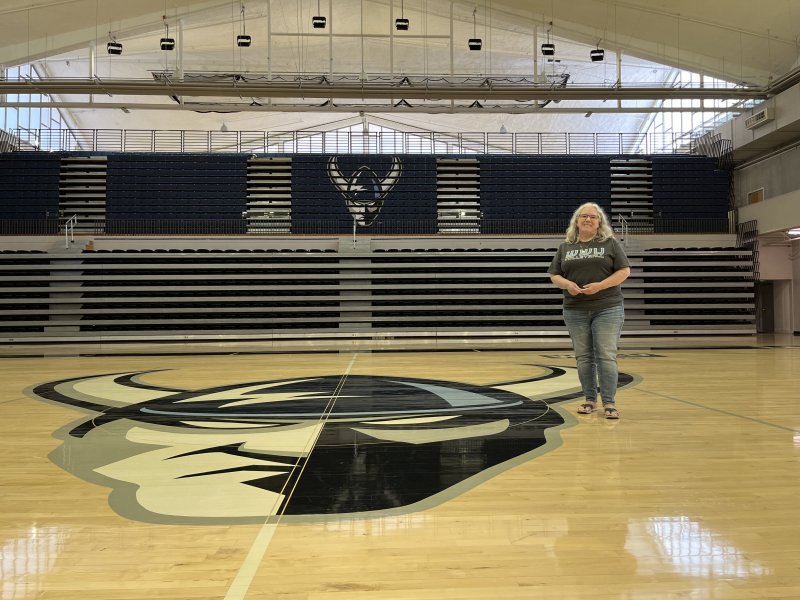 Kay Davis stands at the center of WECU Court in Carver.