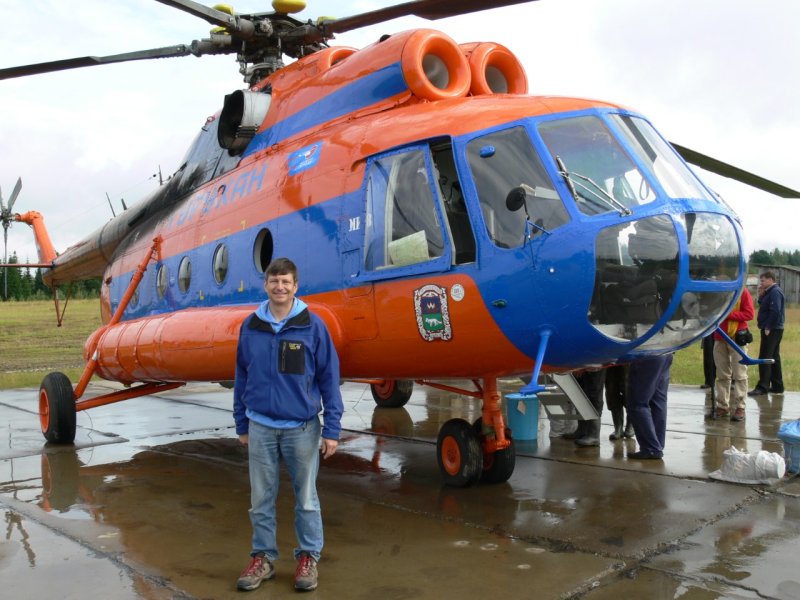 Ed Vajda stands in front of a Russian helicopter