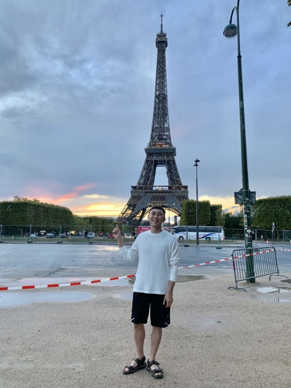 Richard Li stands in Paris in front of the Eiffel Tower