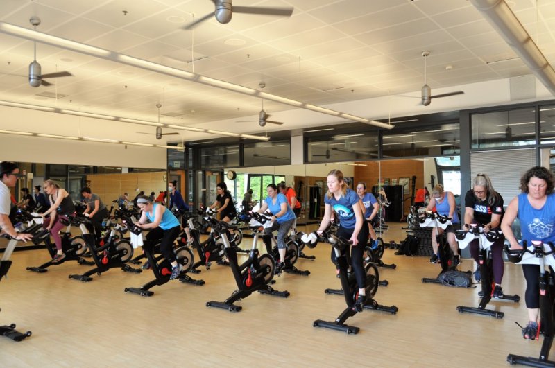 Western employees in a spin class riding stationary bikes