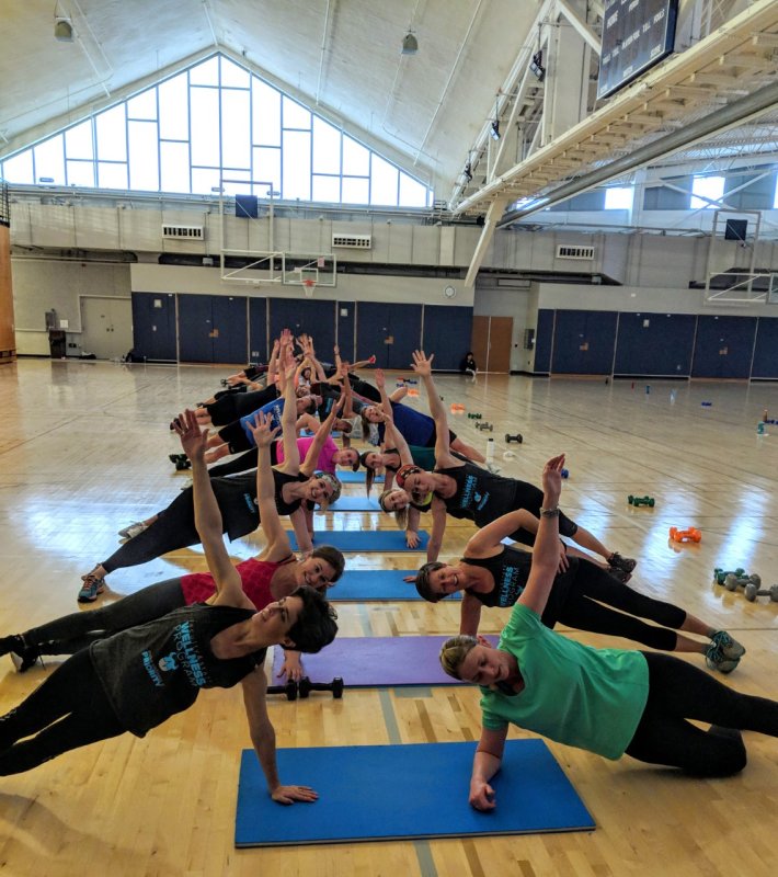 Employees doing yoga in Carver Gym