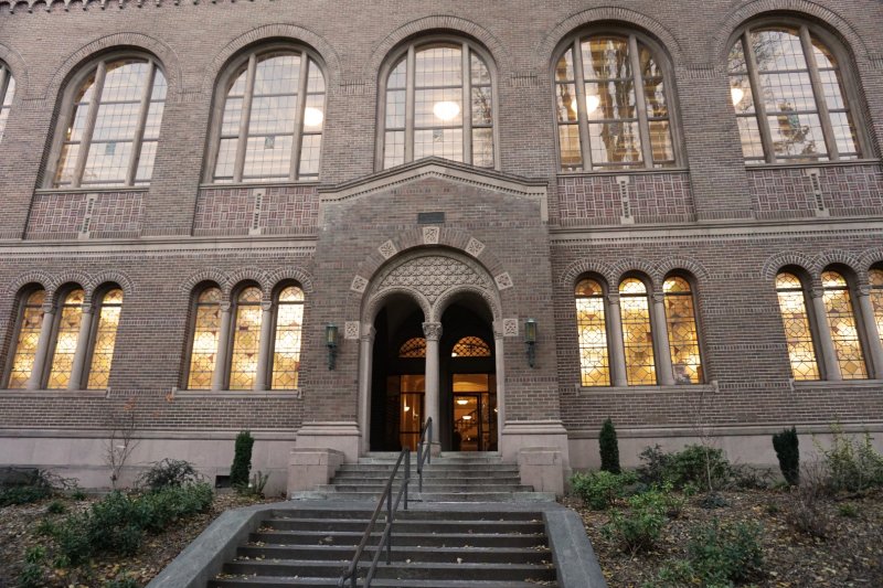 The front facade of Wilson library; the sun is reflected in the windows