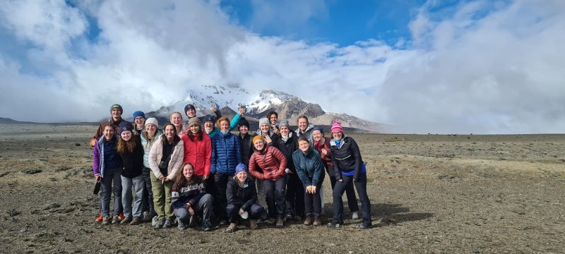 The Honors program poses for a group photo; behind them is the misty peak of Chimbarazo volcano.