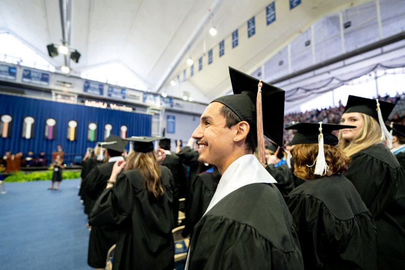 A student smiles during commencement.