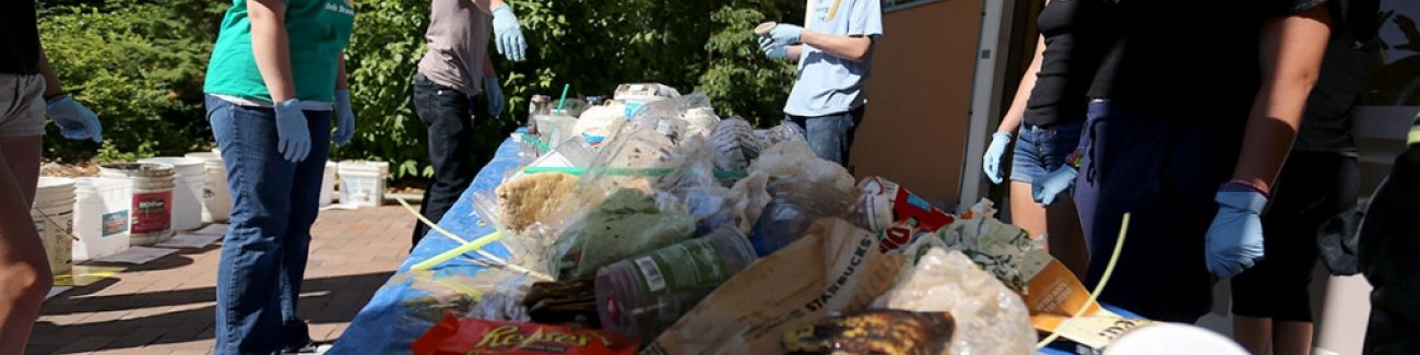 High school students participating in College Quest conducted an audit of campus garbage July 19 outside of Carver gym on campus. The audit requires garbage to be sorted and weighed by hand. Garbage included banana peels, coffee cups, napkins and bottles.
