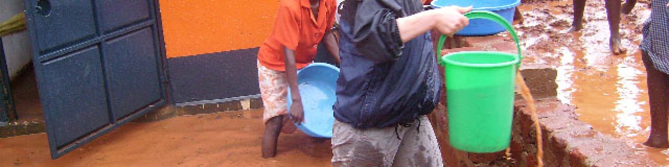 Kristen Pettit, a WWU community health major, bails water from a Ugandan school after a recent downpour there. Pettit is completing her internship in Uganda this summer with the VOLSET Foundation. Photo courtesy of Kristen Pettit