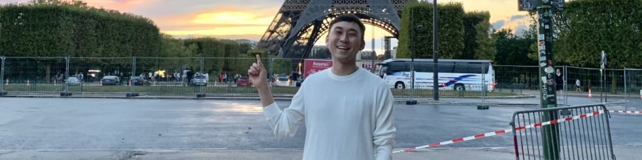 Richard Li stands in Paris in front of the Eiffel Tower