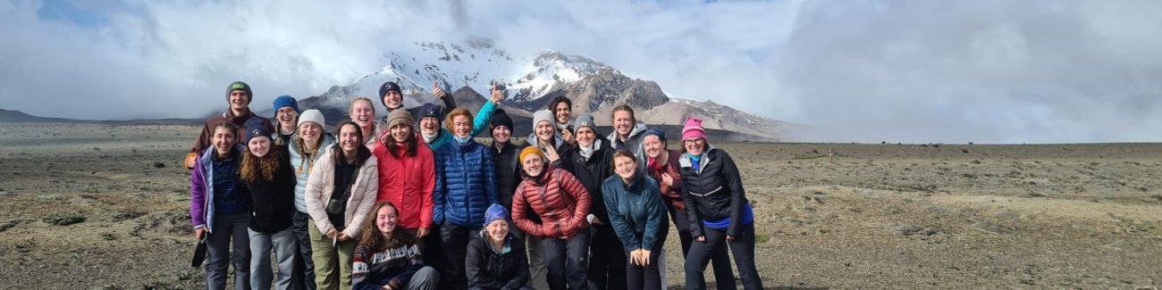The Honors program poses for a group photo; behind them is the misty peak of Chimbarazo volcano.