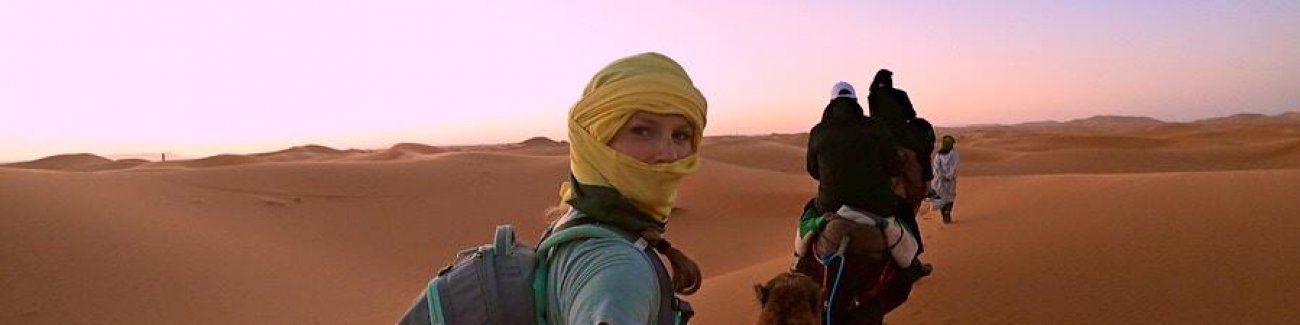WWU student Nicole Crook on the back of a camel in Morocco on her Gilman scholarship