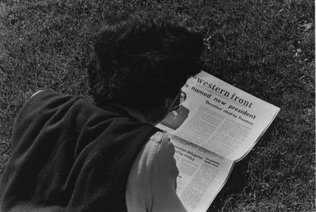 A WWU student in 1968 reads the issue of The Western Front announcing Flora as Western's new president. Photo courtesy of WWU Special Collections.
