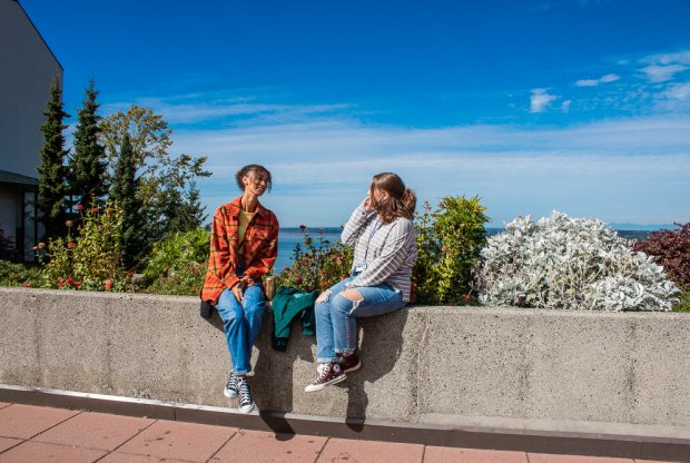 Students sit in the sun near the Viking Union