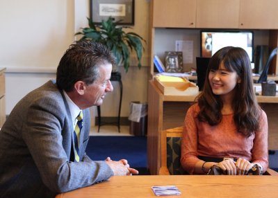 President Bruce Shepard asks Asia University America Program graduate Kyoka Hirano about her favorite thing about Western Friday morning. Shepard welcomed four AUAP graduates to his office Friday and is visiting Asia this week. When Shepard was 18, he did