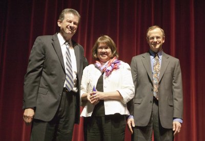 Marlene Harlan, center, director of Marketing and Summer Programs for Extended Education, receives the award from President Bruce Shepard and Vice Provost Steven Vanderstaay.