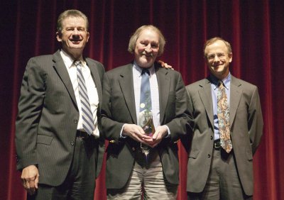 Rick Osen, center, assistant dean for Administration and Planning in Western Libraries, receives the award from President Bruce Shepard and Vice Provost Steven Vanderstaay.