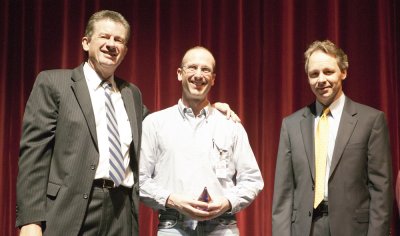 Chris Hadley, center, engineer with Facilities Management, receives the award from President Bruce Shepard and Vice President for Business and Financial Affairs Rich Van Den Hul.