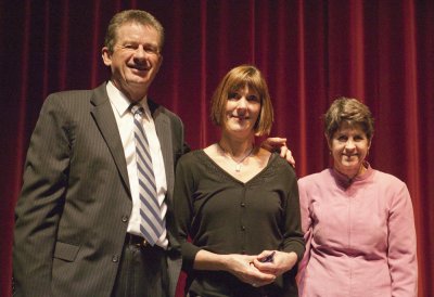 Jane Wareing, center, patient services coordinator for the Counseling Center, receives the award from President Bruce Shepard and Senior Vice President for Enrollment and Student Services Eileen Coughlin.