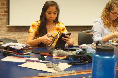 A Whatcom Community College student participating in the 2015 Connecting Communities project works on a sock monkey for charity. Courtesy photo