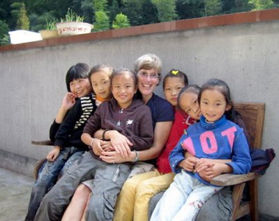 Associate Professor of Political Science Kristen Parris poses with Chinese children in Suichang. Courtesy photo