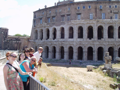 Deb Currier is pictured in front of the Theater of Marcellus in Rome with students on her last tour.