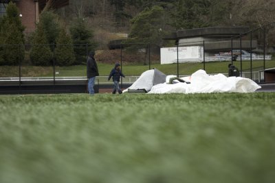 Workers survey piles of dirt, covered by tarps to keep it dry, as rolls of turf are laid on the softball field as a part of the renovations to the field area. Improvements were also made to the fencing and dugouts as part of the renovation. Photo by Jerem