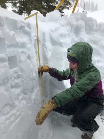 Constance Webb, a student in 'Global Change in the Cryosphere' measures the snow pit depth