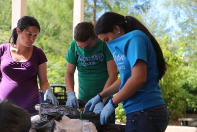 Class instructor Katie Fleming works with Zachary Toombs and Katherine Landoni to sort trash as part of a waste audit in the summer College Quest class at Western Washington University. Photo by Preston VanSanden | Communications and Marketing intern