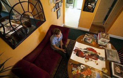 Katy Frank, 32, a custodian at Western Washington University, talks about the mindset she has when she creates collage pieces in her Bellingham home. Photo by Matthew Anderson | WWU