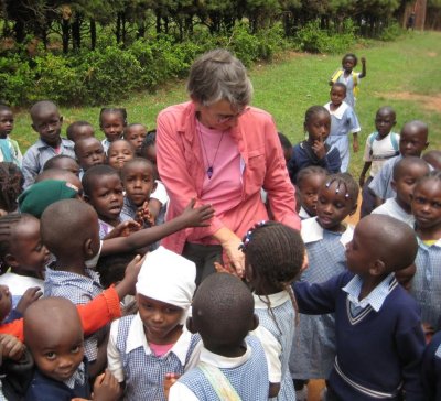Marie Eaton is shown here surrounded by schoolchildren in Kenya.