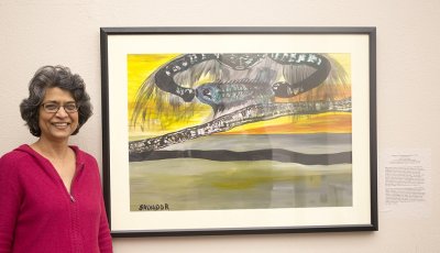 English professor Rosanne Kanhai poses next to the painting she donated to the university in honor of her late husband, Paul Gaslow. Photo by Matthew Anderson | WWU Communications and Marketing