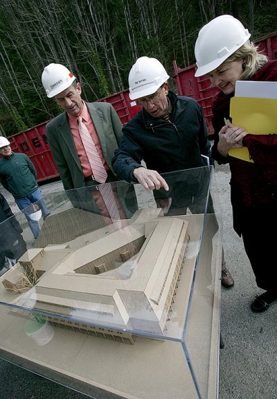 During a tour of construction last January, WWU Facilities Management Director Tim Wynn, middle, shows a model of the completed Miller Hall project to WWU President Bruce Shepard, left, and Sherry Burkey, Western's associate vice president for University 