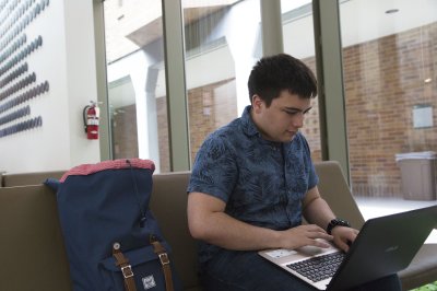 Freshman Ian Roessler get some homework done in Miller Hall while waiting to meet with a professor