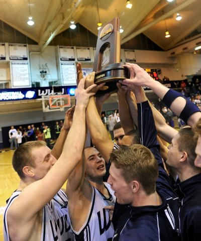 Members of the WWU men's basketball team hold their NCAA Div. II regional trophy aloft during an on-court celebration after their 56-50 win over Seattle Pacific University on Monday, March 12, in Carver Gymnasium. Photo courtesy of WWU Athletics