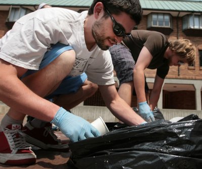 Western Washington University students Matt Moroney, left, and Colin Wahl sort through garbage during a 2009 campus waste audit at the university. Students for Renewable Energy, the Air and Waste Association and the Office of Sustainability conducted a ca