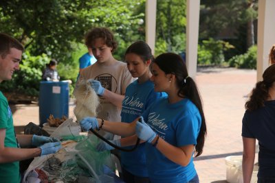Zachary Toombs, Nick Steele, Macy Milnes and Katherine Landoni sort trash as part of a waste audit in the summer College Quest class at Western Washington University. Photo by Preston VanSanden | Communications and Marketing intern