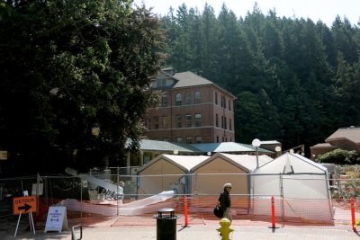 Certified asbestos workers have tents set up to aid in the safe removal disposal of contaminated dirt surrounding the aging water main currently being replaced on the Western Washington University campus. Photo by Maddy Mixter | University Communications 