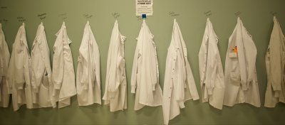 WWU students' lab gowns hang on a new row of hooks at the lab.