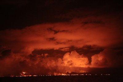 The night scene as lava pours into the sea