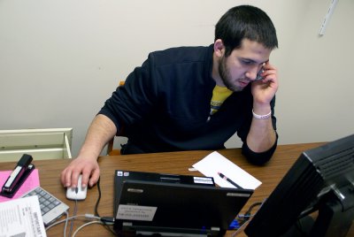 WWU senior Bradley Alfi double checks a tax form with a customer over the phone. "Some of us will do taxes in the future, so this is practice for us to interact with people," Alfi said. "It also helps us to better understand tax lingo and get a solid foun